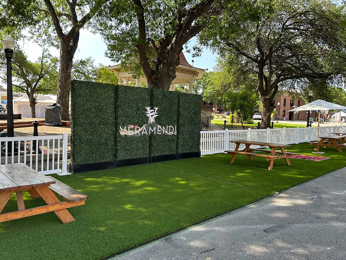 Veramendi sponsor sign made of turf and white lettering at Saengerfest picnic area.